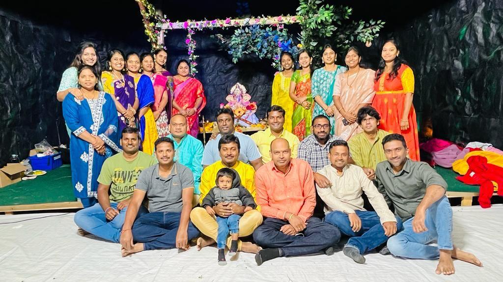 Community group gathered before the decorated Ganesh mandap, 2023