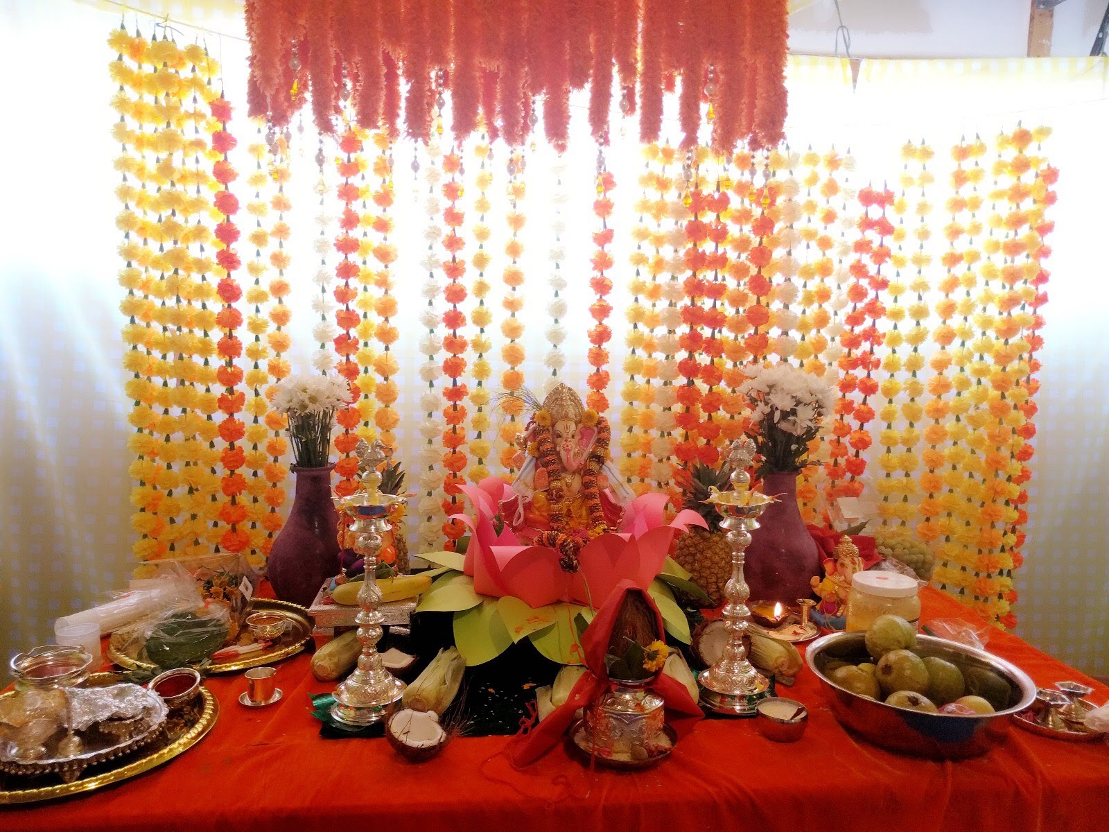Ganesh idol on a lotus with marigold garland backdrop, 2017
