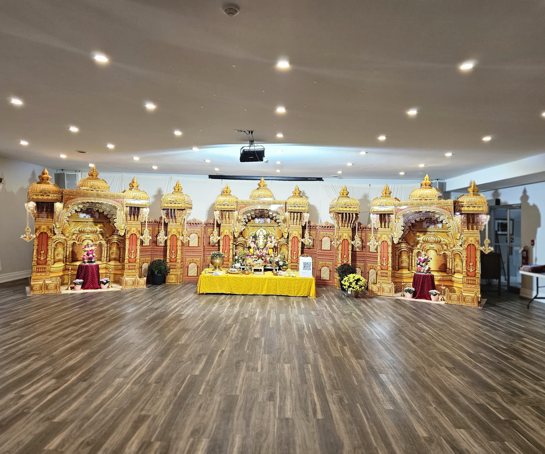 The grand golden palace-style Ganesh mandap with offerings, 2025