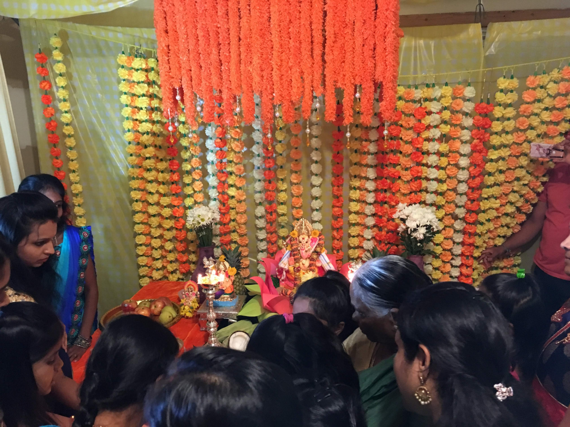 Devotees gathered around the Ganesh mandap during aarti, 2017