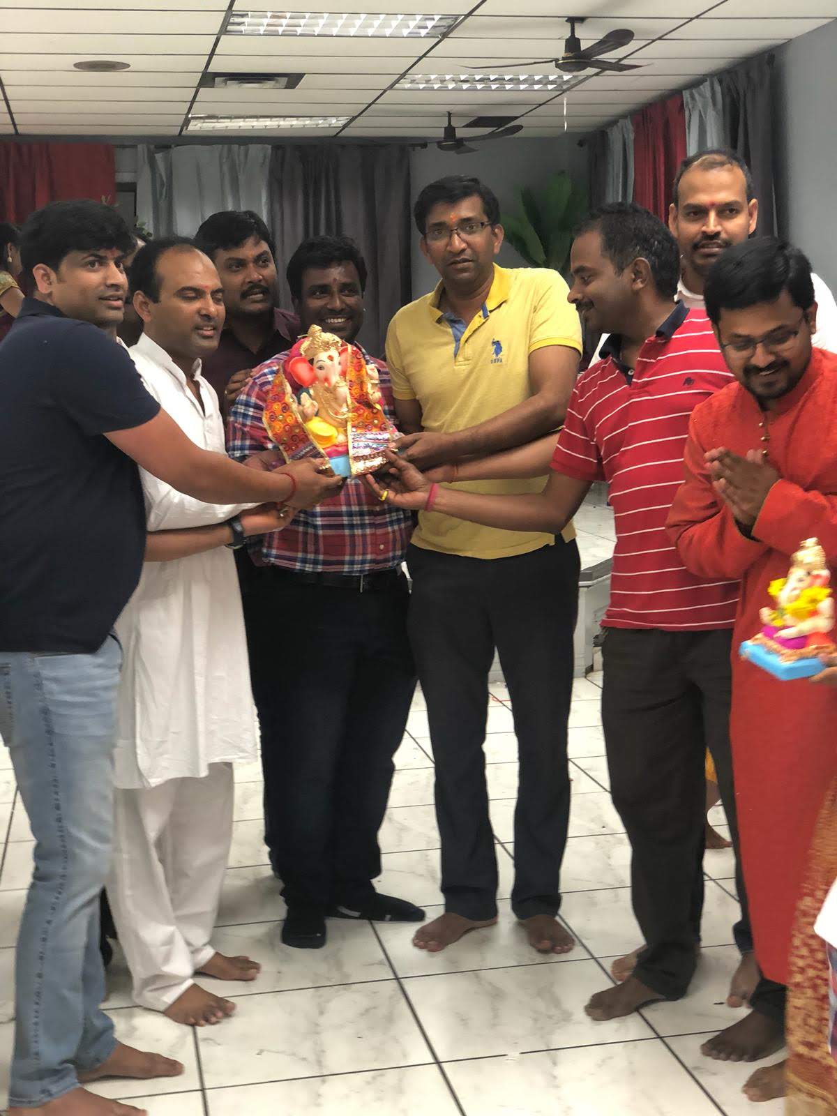 Community members carrying the Ganesh idol together, 2018