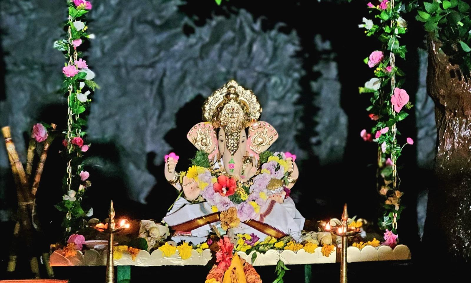 Lord Ganesha adorned with flowers and lamps in the ornate mandap, 2023