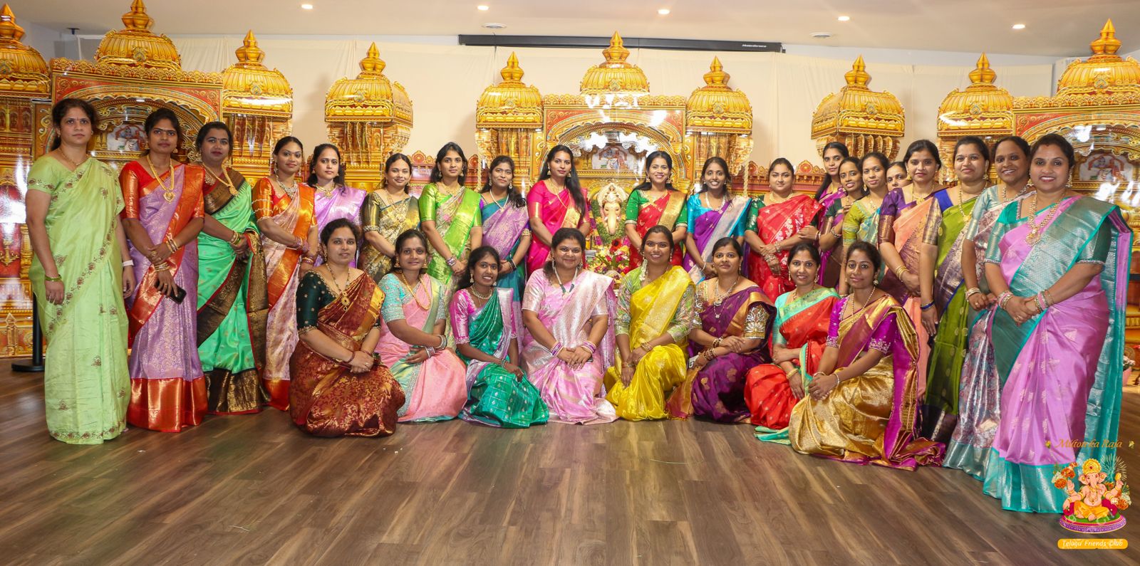 Women of the community in colorful sarees before the Ganesh mandap, 2025