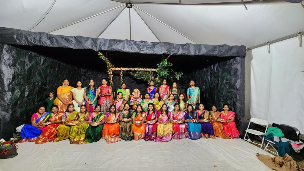 Women of the Telugu Friends Club community gathered in front of the Ganesh mandap, 2023